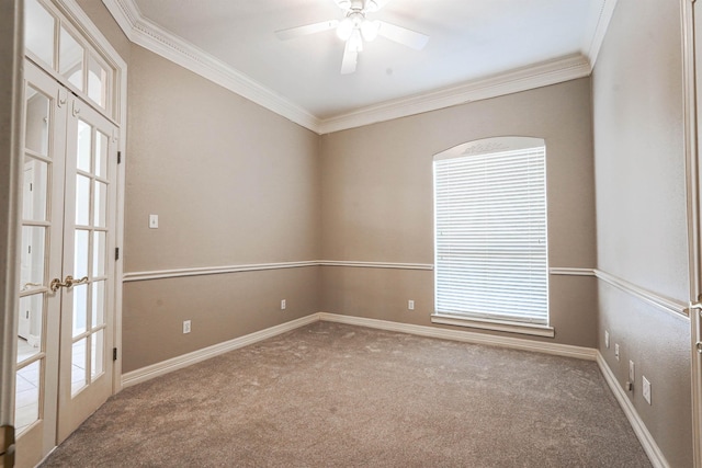 carpeted empty room featuring french doors, ceiling fan, and crown molding