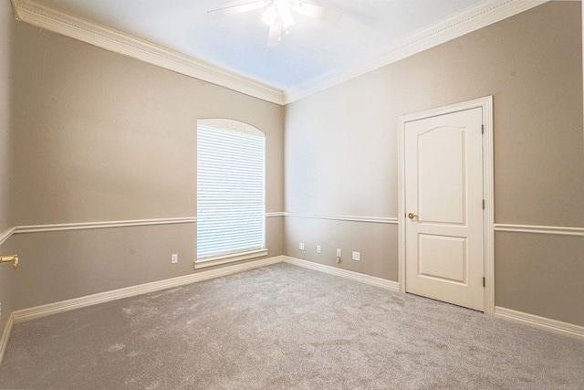 carpeted empty room featuring plenty of natural light, crown molding, and ceiling fan