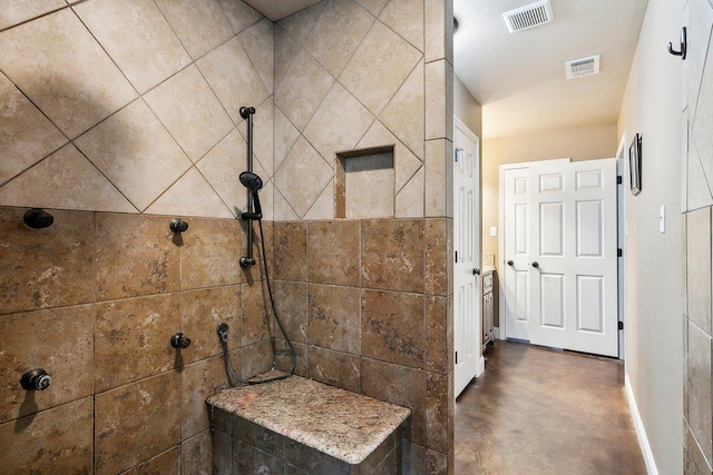 bathroom with a tile shower