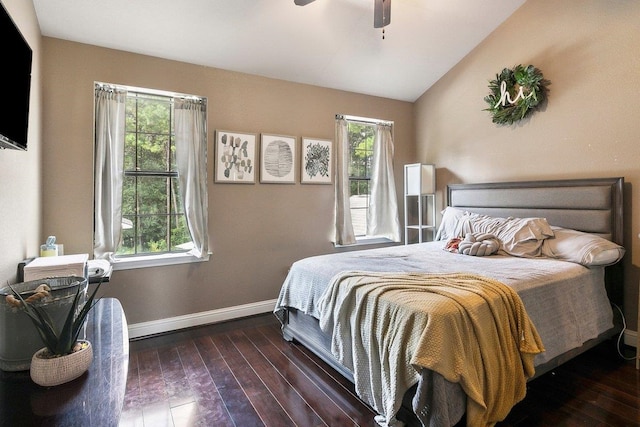 bedroom featuring ceiling fan, dark wood-type flooring, and lofted ceiling