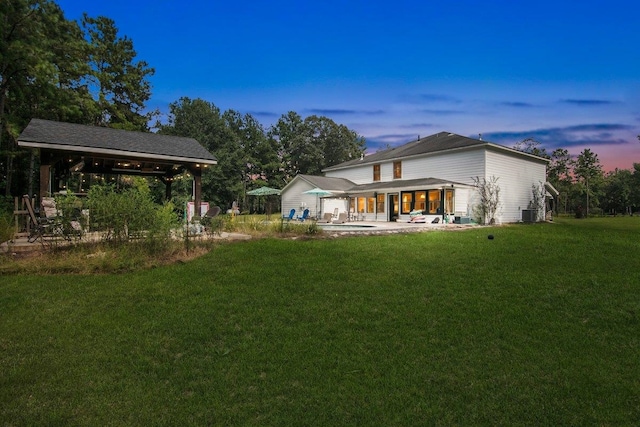 yard at dusk with a gazebo and a patio