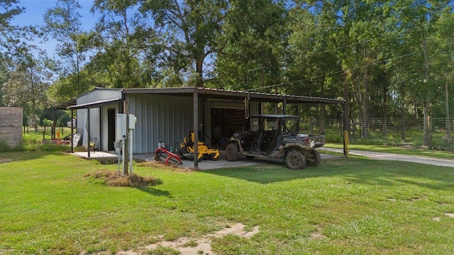 view of outdoor structure with a carport and a yard