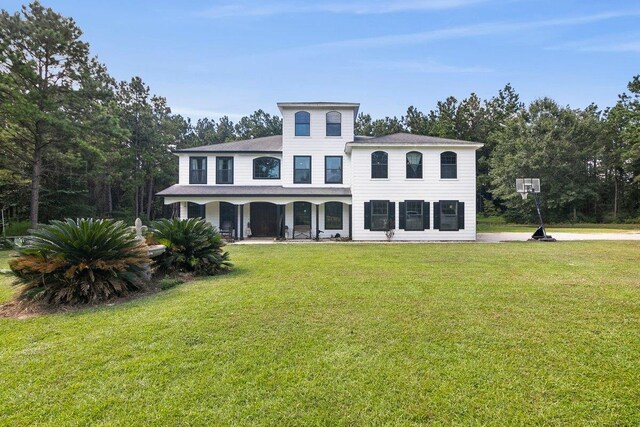 view of front facade with covered porch and a front lawn