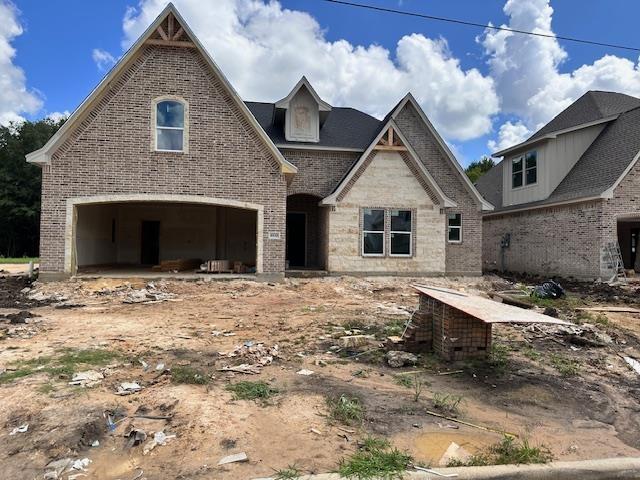 8530 Sana Dr, Beaumont, TX 77713 - view of front of property featuring brick siding, an attached garage, and stone siding