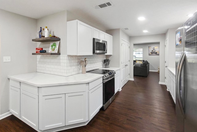 kitchen featuring white cabinets, backsplash, appliances with stainless steel finishes, and dark wood-type flooring