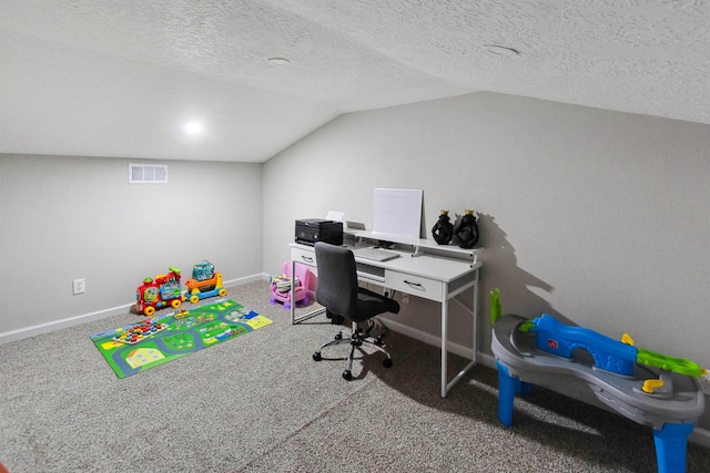 home office with a textured ceiling, carpet floors, and vaulted ceiling