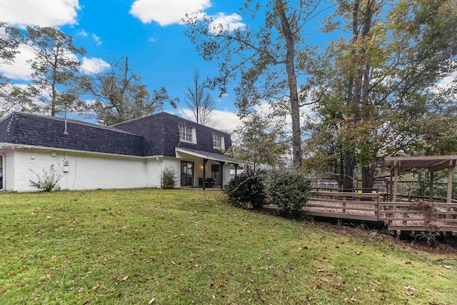 exterior space featuring a lawn and a wooden deck