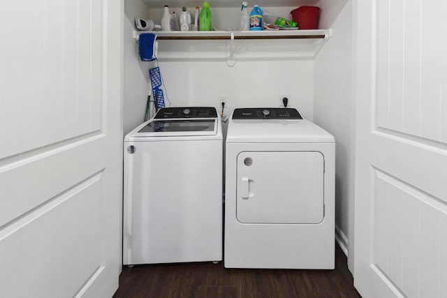 clothes washing area with washer and dryer and dark hardwood / wood-style floors