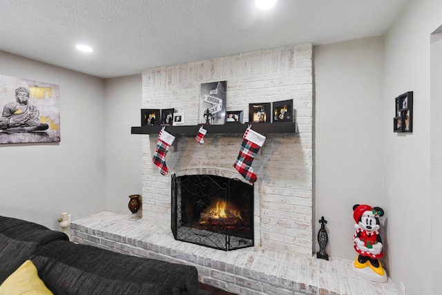 living room featuring a fireplace and a textured ceiling