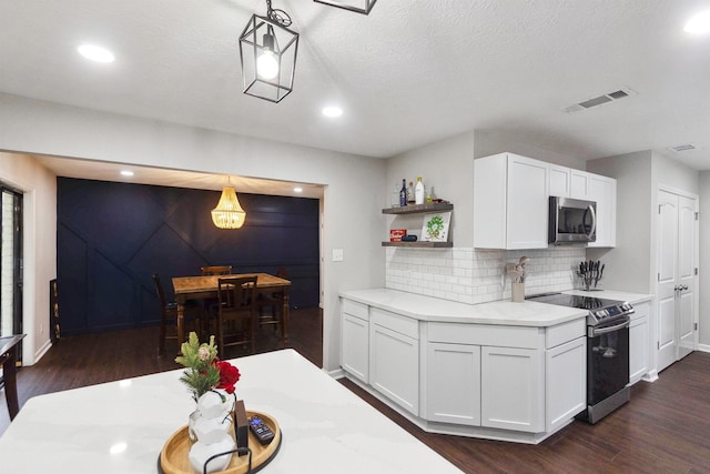 kitchen with hanging light fixtures, stainless steel appliances, tasteful backsplash, dark hardwood / wood-style flooring, and white cabinets