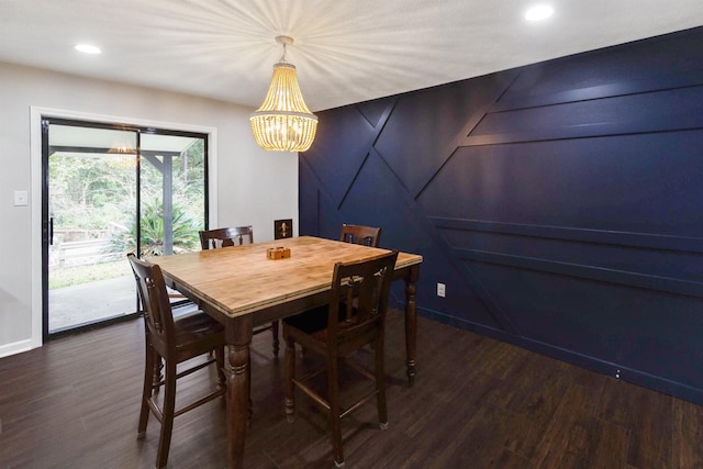 dining area with an inviting chandelier and dark wood-type flooring