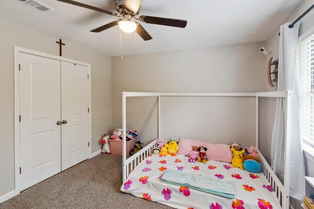 carpeted bedroom with a closet and ceiling fan