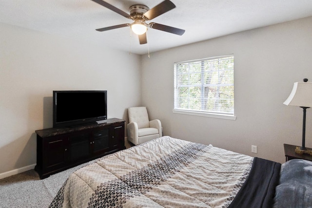 bedroom featuring ceiling fan and light carpet