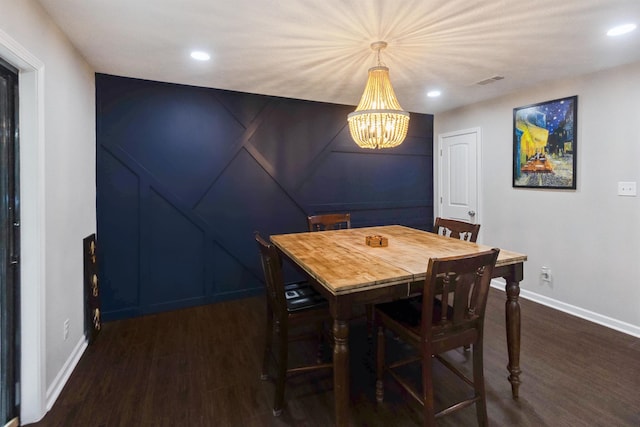 dining space with a chandelier and dark wood-type flooring