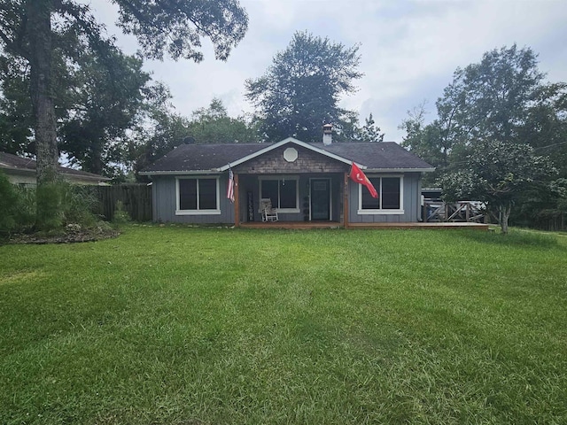 back of house with a lawn