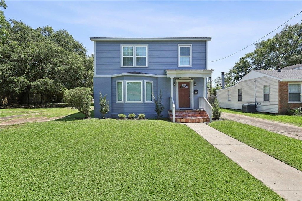2255 Harrison St, Beaumont, TX 77701 - traditional-style house featuring central AC unit and a front lawn
