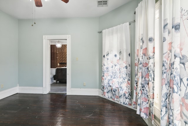 spare room featuring ceiling fan and dark hardwood / wood-style flooring