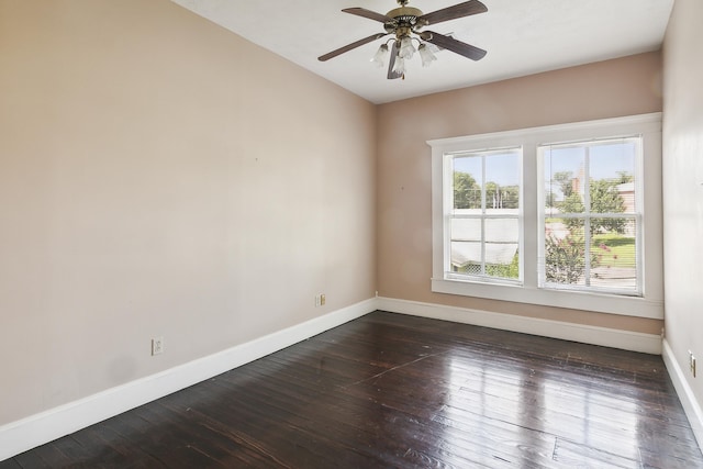 empty room with ceiling fan and dark hardwood / wood-style floors