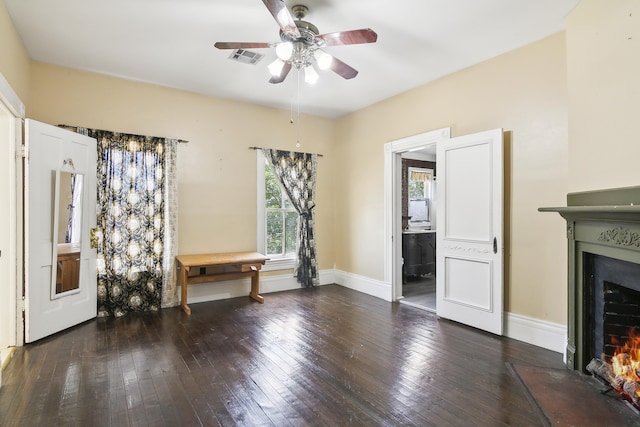 interior space featuring dark wood-type flooring and ceiling fan