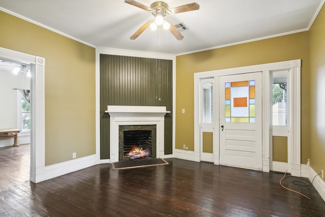 unfurnished living room with ceiling fan, dark hardwood / wood-style flooring, and ornamental molding