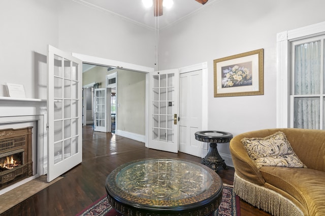 interior space featuring crown molding, ceiling fan, french doors, a high ceiling, and dark hardwood / wood-style floors