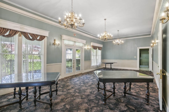 dining room featuring french doors, crown molding, and a chandelier