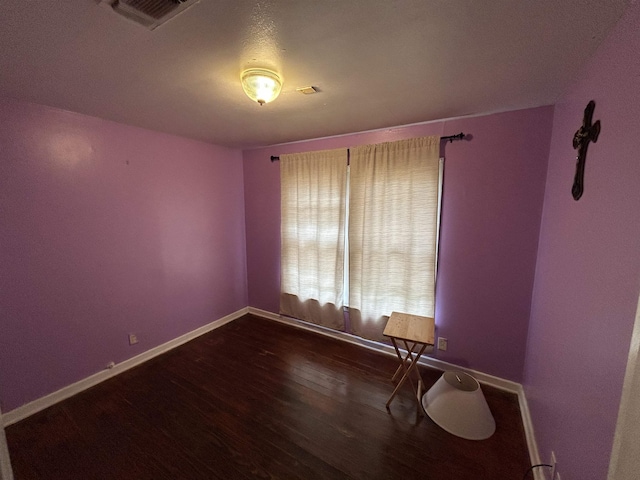 unfurnished room with hardwood / wood-style flooring