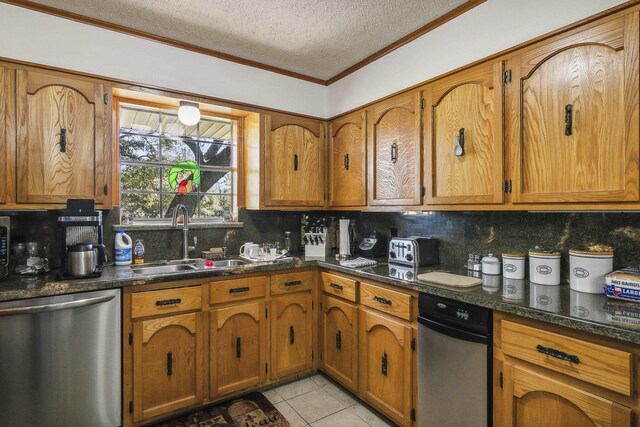 kitchen featuring dishwasher, dark stone counters, sink, light tile patterned floors, and a textured ceiling