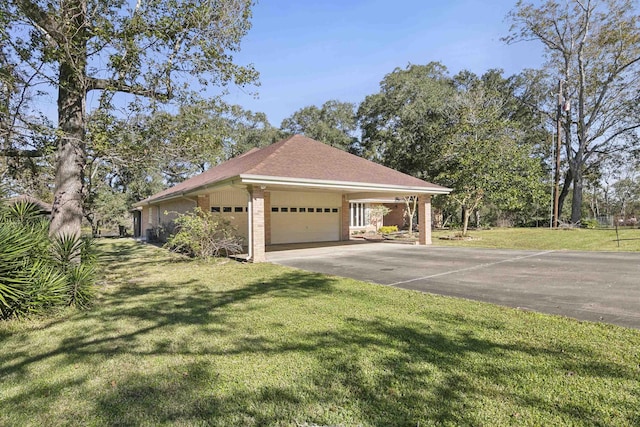 view of side of property featuring a carport, a garage, and a yard