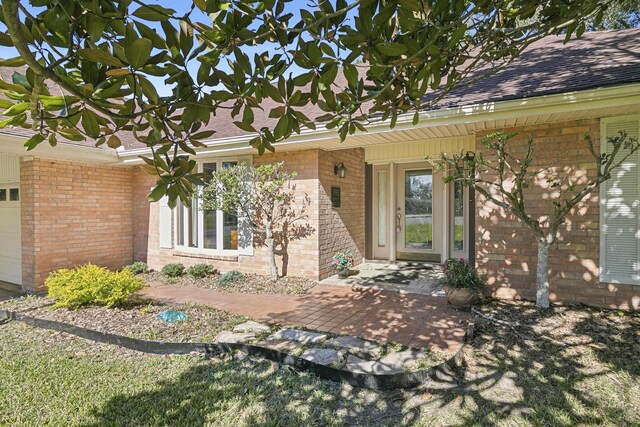 doorway to property with a garage