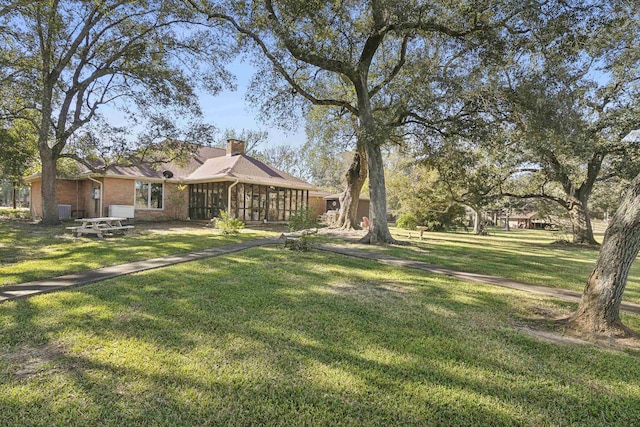 view of yard featuring a sunroom