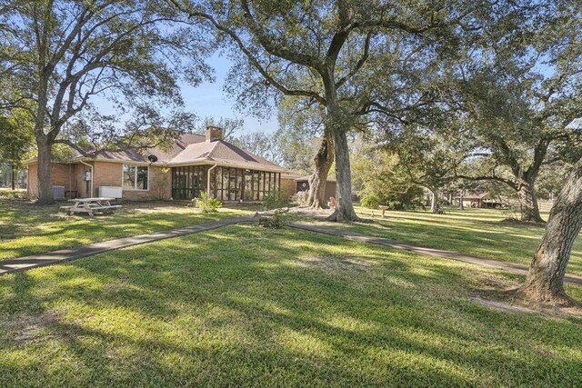 view of yard featuring a sunroom