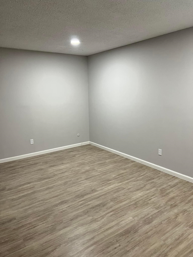 2210 N St, Beaumont, TX 77701 - empty room featuring a textured ceiling and light wood-type flooring