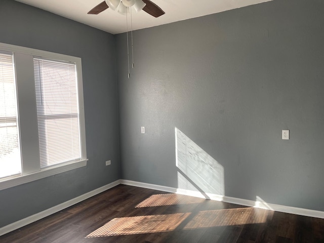 spare room with ceiling fan and dark hardwood / wood-style floors