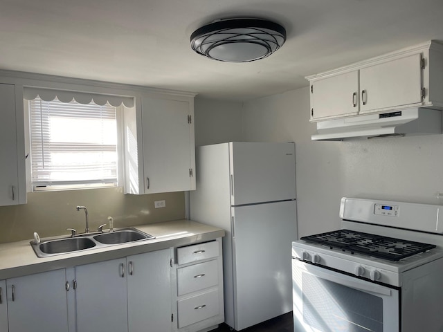 kitchen featuring white cabinets, white appliances, and sink