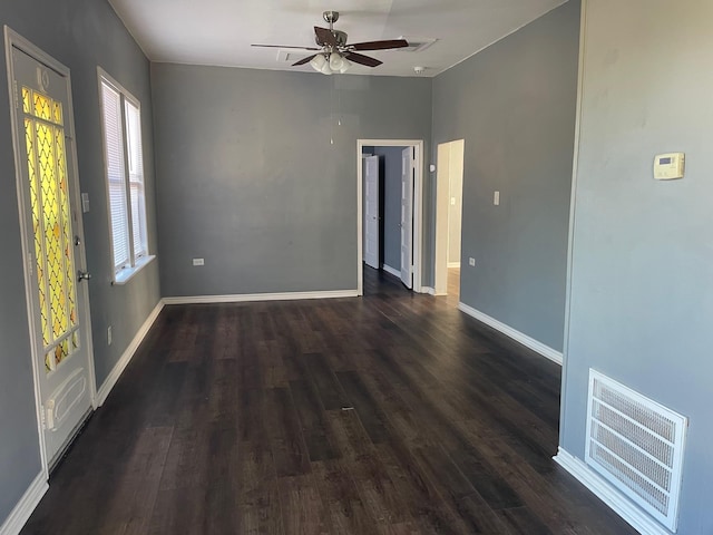 spare room featuring ceiling fan and dark wood-type flooring