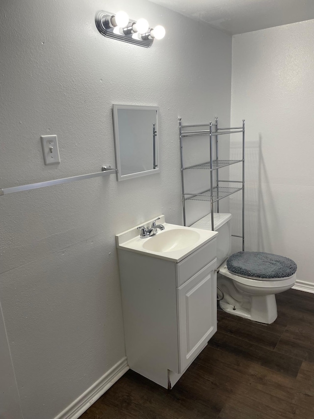 bathroom featuring hardwood / wood-style floors, vanity, and toilet