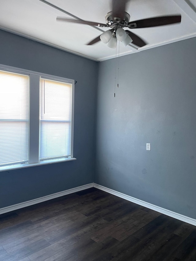 empty room featuring dark hardwood / wood-style floors, ceiling fan, and crown molding