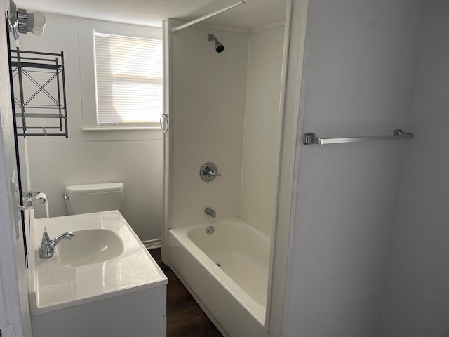 full bathroom featuring hardwood / wood-style floors, vanity, shower / bath combination, and toilet