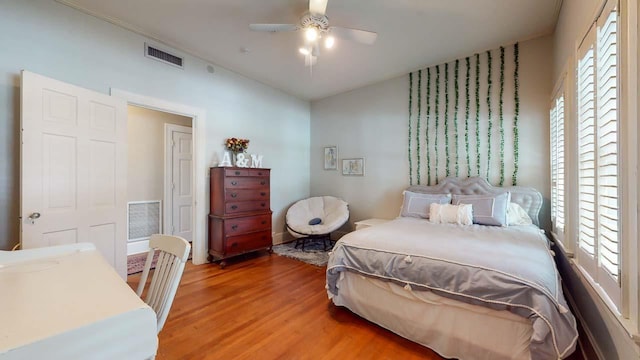 bedroom with ceiling fan and wood-type flooring