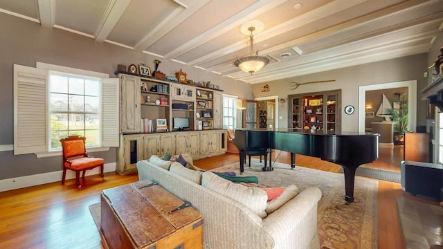 living area featuring beamed ceiling and light wood-type flooring