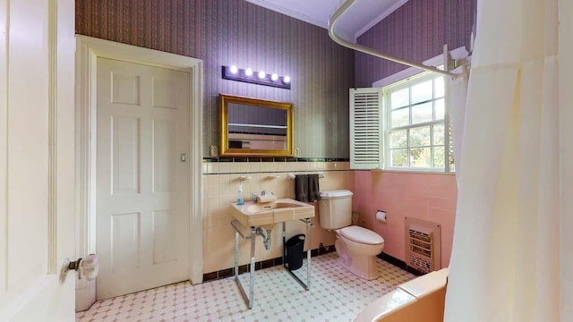 bathroom featuring heating unit and toilet