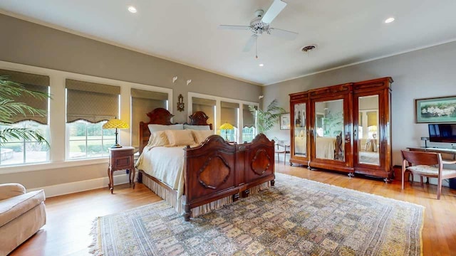 bedroom with ceiling fan and light wood-type flooring