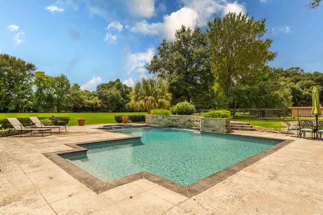 view of swimming pool featuring a lawn, a patio area, and pool water feature