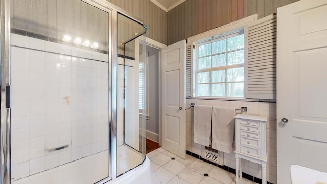 bathroom featuring tile patterned floors and bath / shower combo with glass door