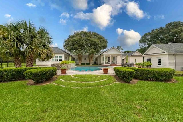 view of pool featuring a lawn and a patio