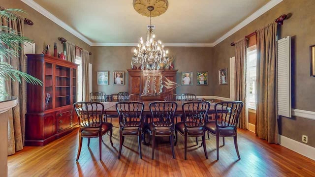 dining area featuring hardwood / wood-style flooring, a notable chandelier, and a wealth of natural light