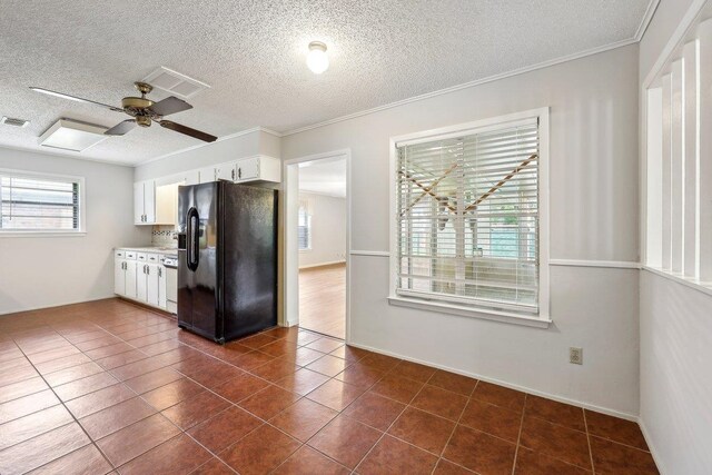 5960 Navajo Trl, Beaumont, TX 77708 - kitchen with black refrigerator with ice dispenser, white cabinetry, a textured ceiling, light countertops, and ceiling fan