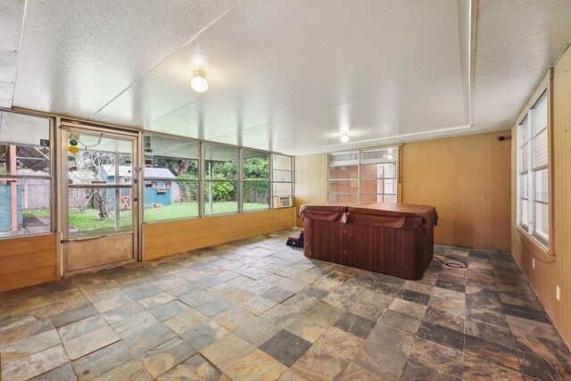 5960 Navajo Trl, Beaumont, TX 77708 - sunroom / solarium featuring a hot tub, plenty of natural light, and cooling unit