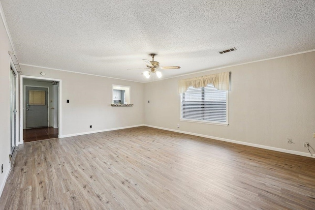 5960 Navajo Trl, Beaumont, TX 77708 - spare room with crown molding, a textured ceiling, wood finished floors, ceiling fan, and baseboards